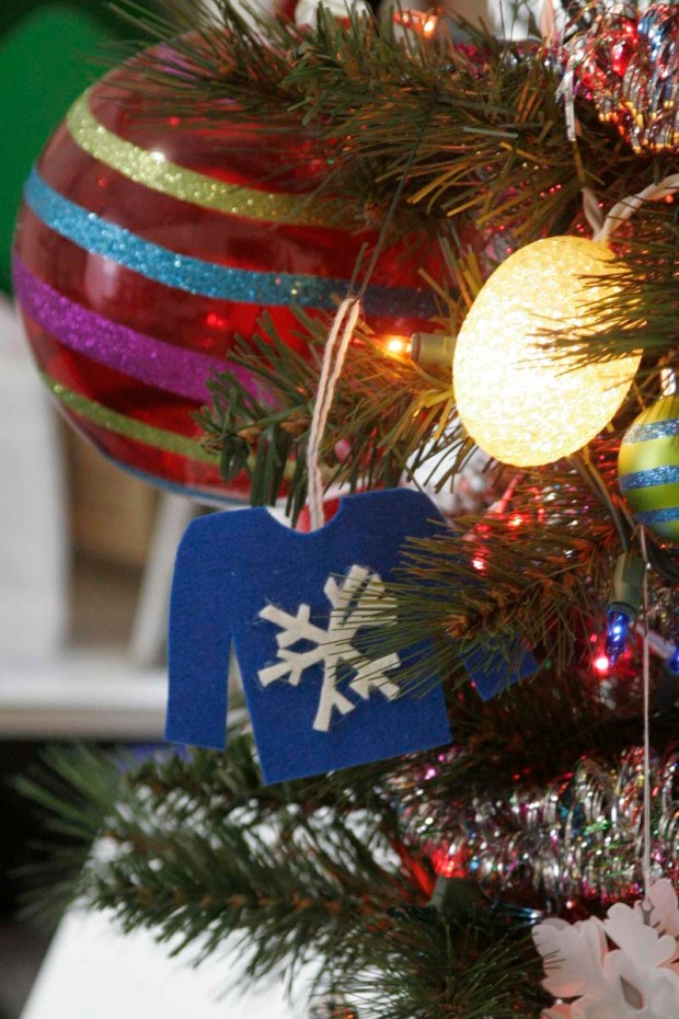 ugly sweater ornament hanging on a christmas tree